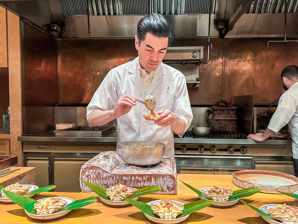 Brandon Go prepares a rice porridge, featuring snow crabs from Hokkaido, Japan, at his restaurant Hayato.