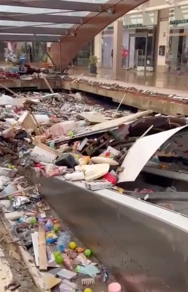 Footage shows the space for car parking below the centre filled to the brim with water and items