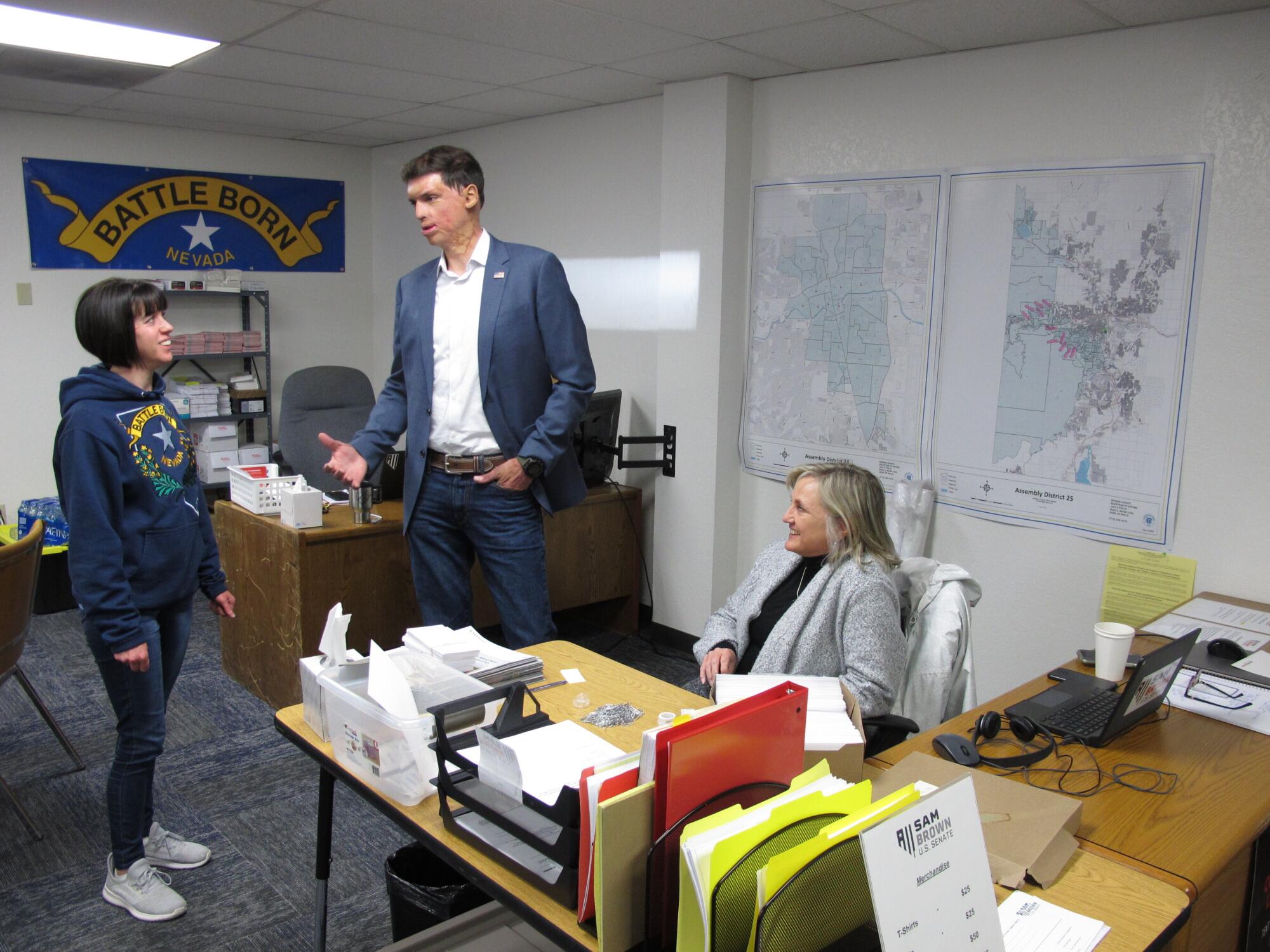 Sam Brown chats with volunteers in a campaign office. 