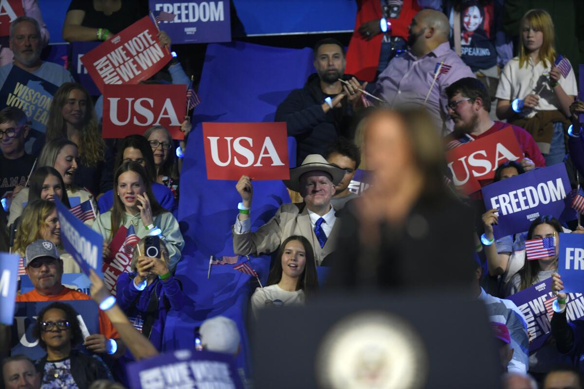 Supporters of Democratic presidential nominee Vice President Kamala Harris listen to her speak 