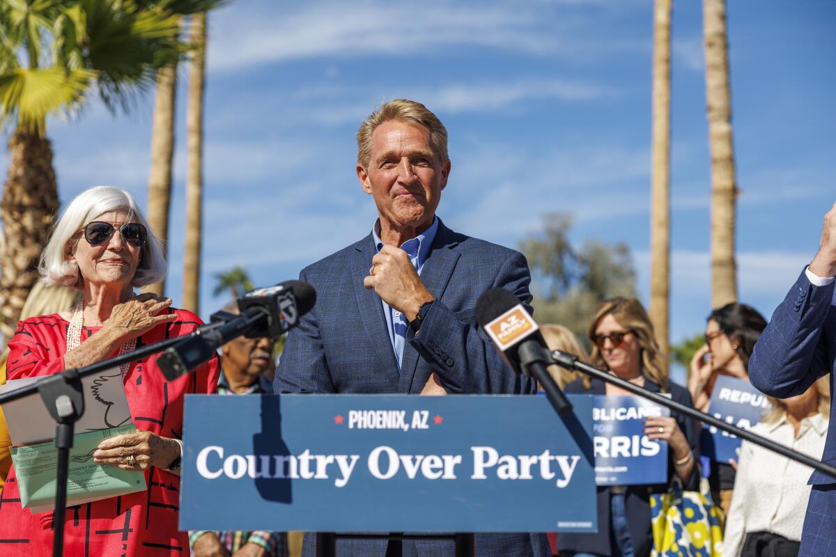 Jeff Flake speaks at a lectern that says "Country over Party"