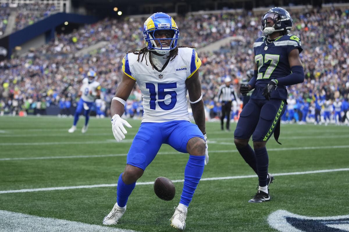 Rams receiver Demarcus Robinson (15) reacts after scoring a touchdown past the Seahawks Riq Woolen (27).