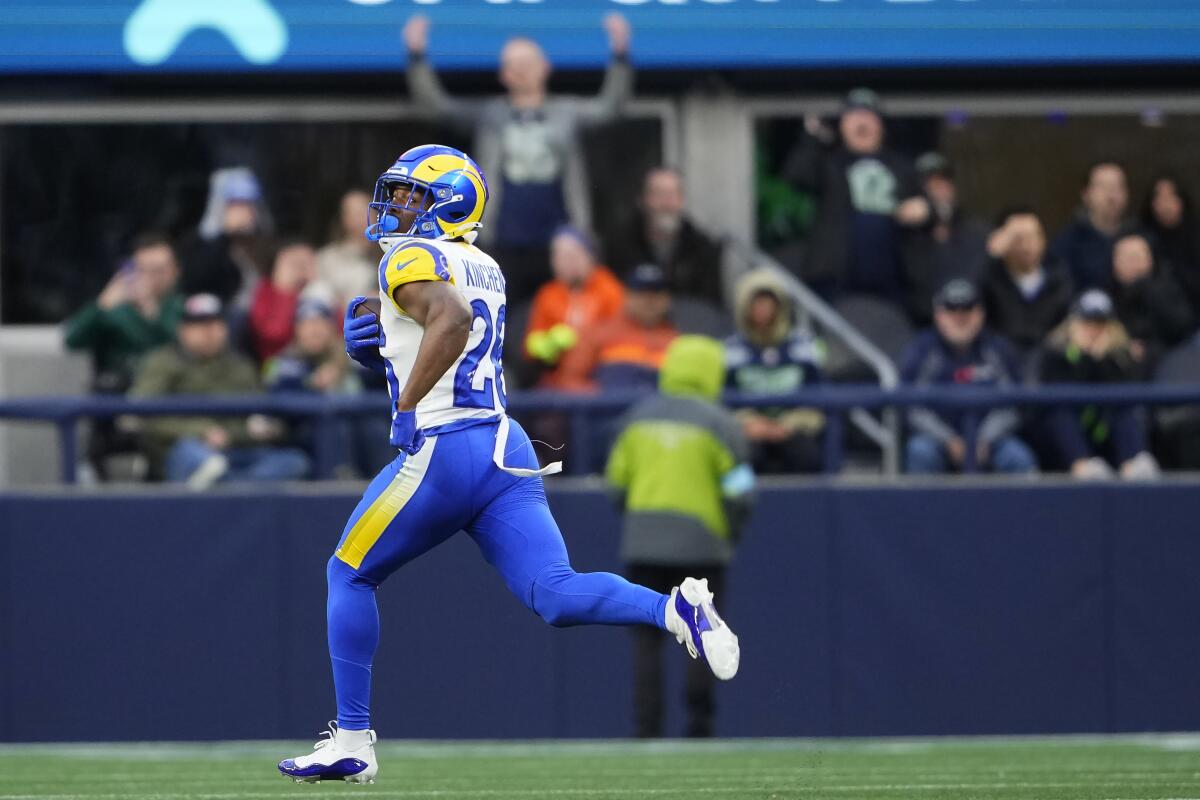 Rams safety Kamren Kinchens (26) returns an interception 102 yards for a touchdown against the Seattle Seahawks.