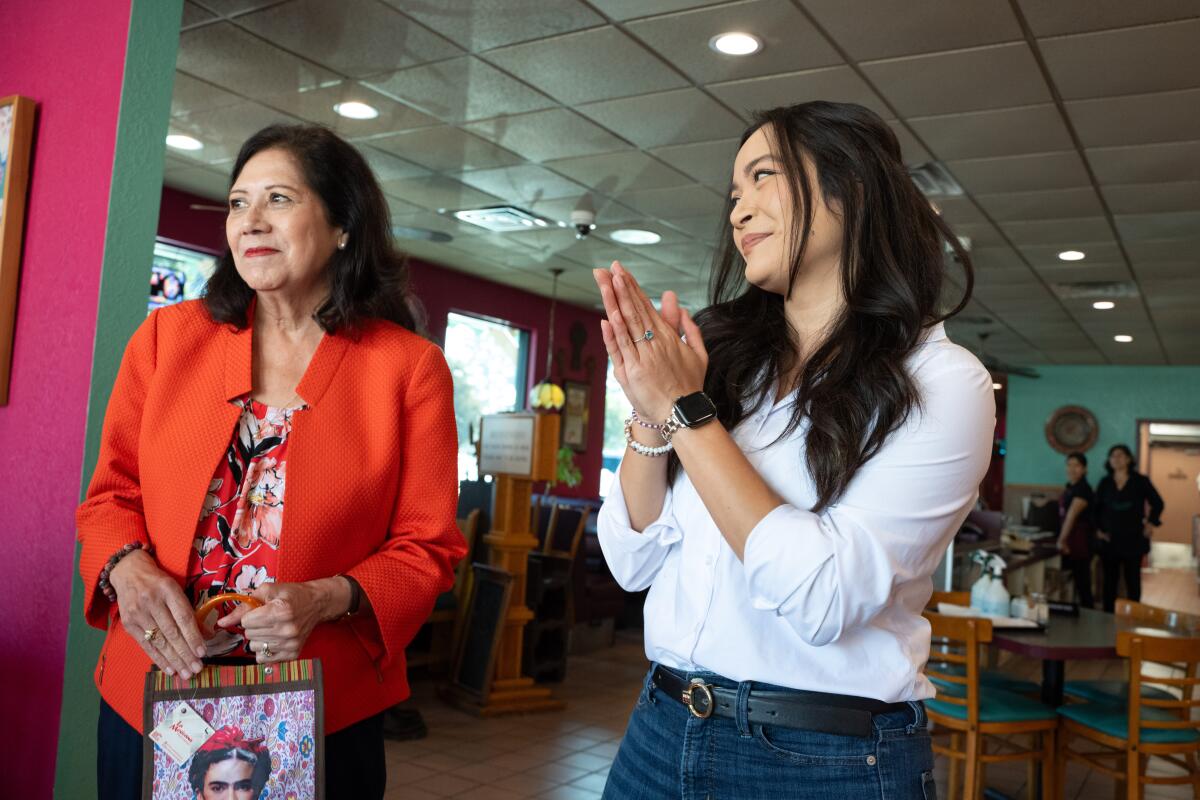 State Assembly candidate Jessica Caloza stands with county Supervisor Hilda Solis, left, at Teresita's in East Los Angeles.