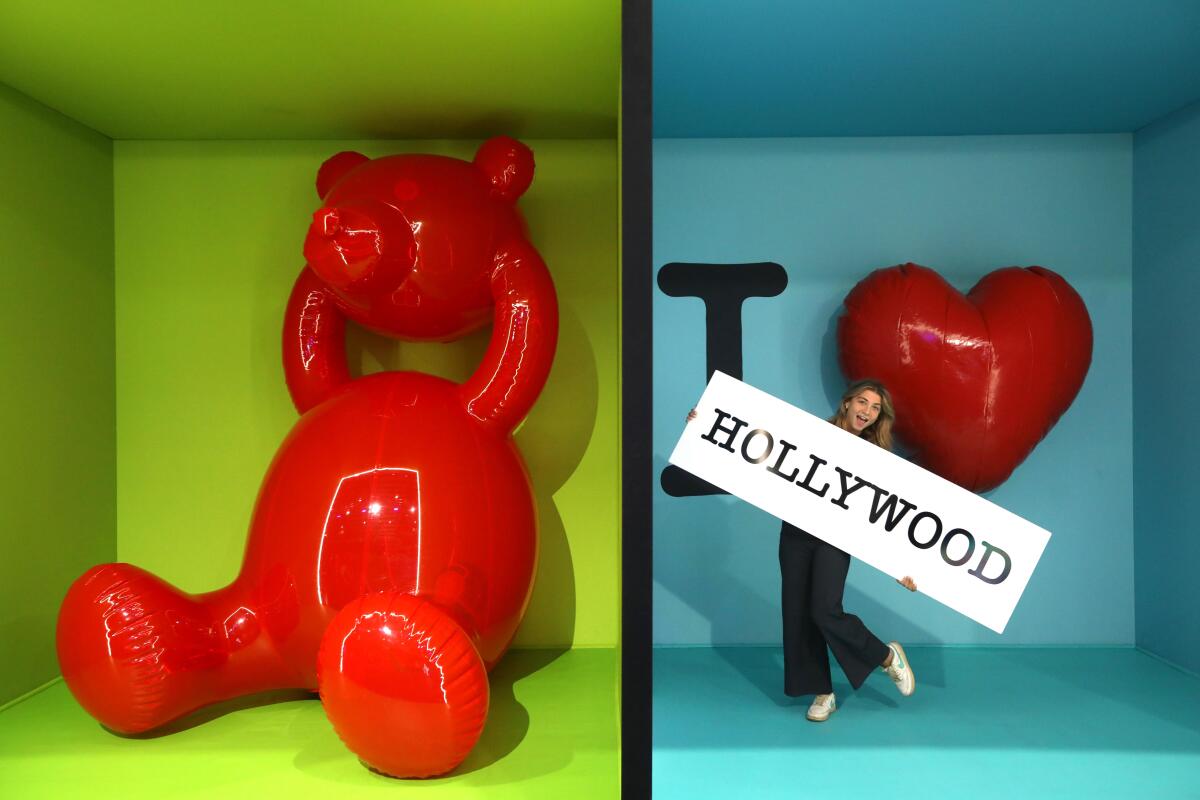 In side-by-side boxes, a red bear lifting off its head and a women posing with "I Love Hollywood" background