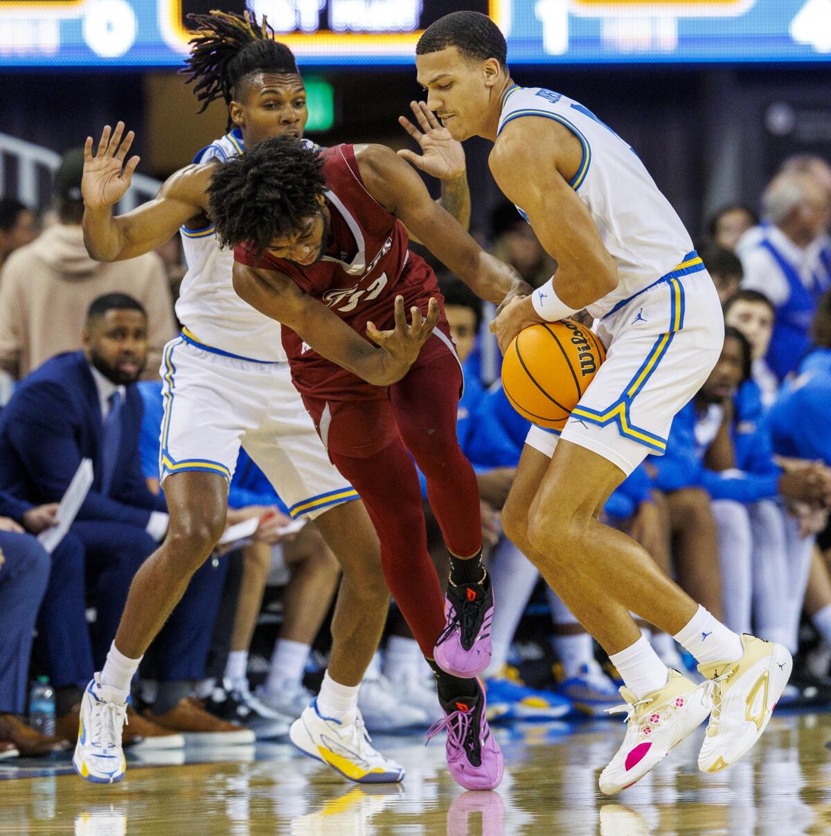 UCLA guard Kobe Johnson, right, steals the ball from Rider guard T.J. Weeks Jr. in the first half Monday.