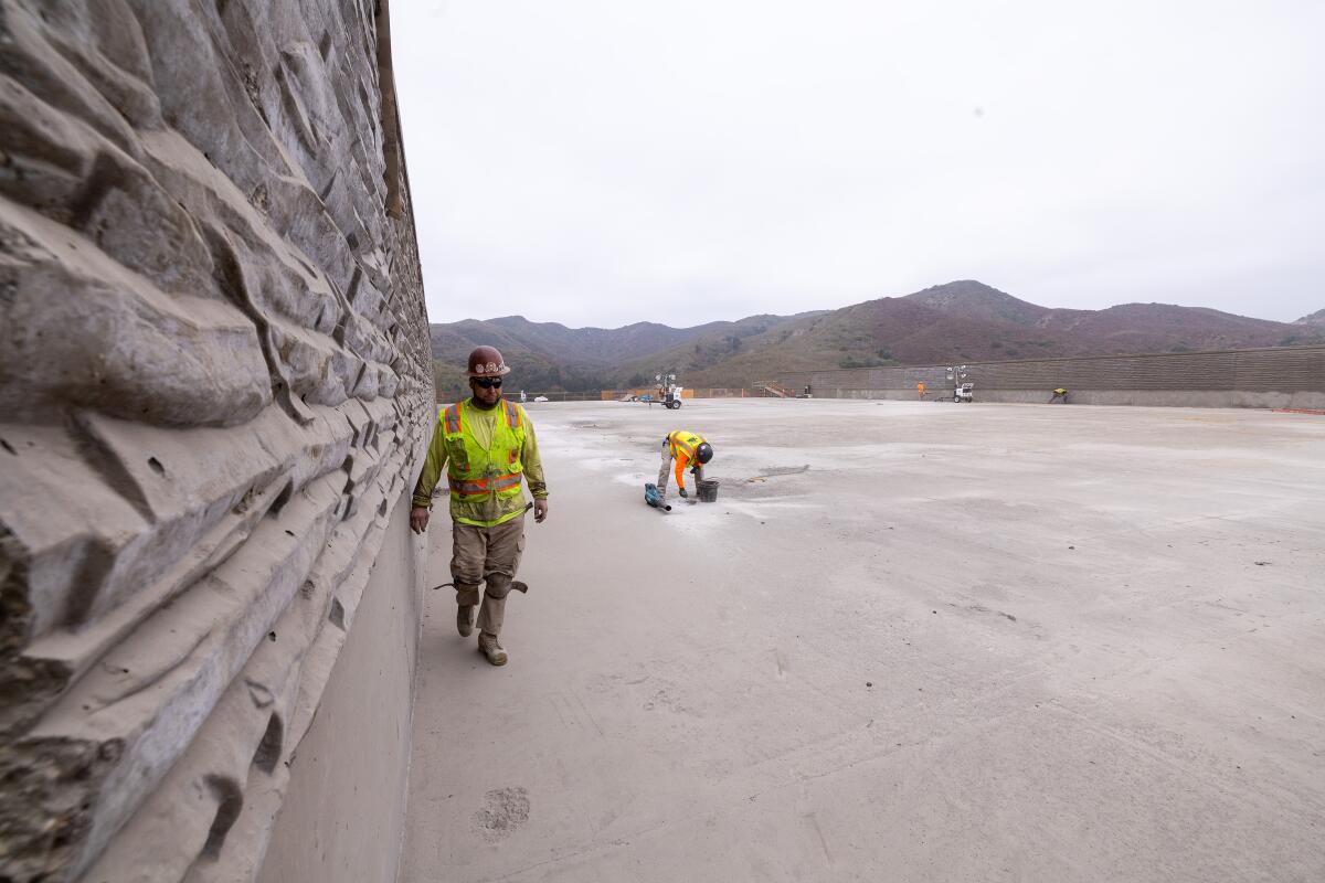 Workers prepare the deck for waterproofing on the Wallis Annenberg Wildlife Crossing in Agoura Hills.