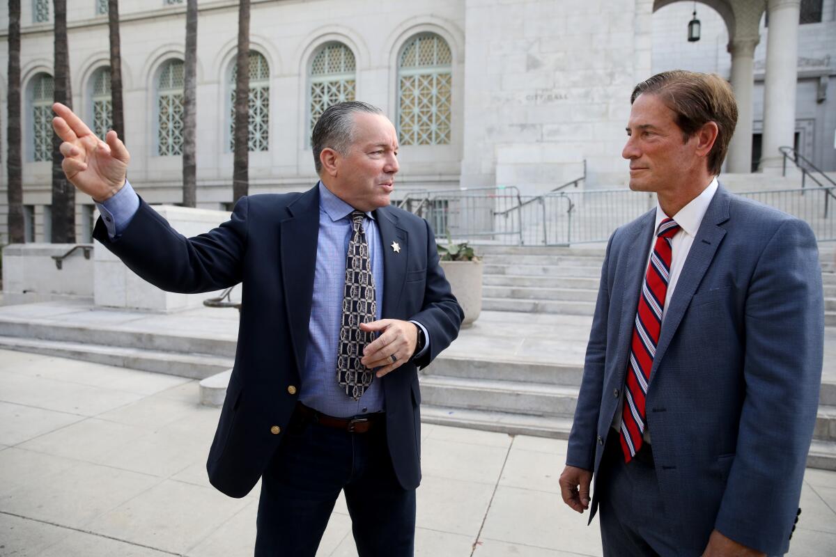 Alex Villanueva talks with Nathan Hochman outside Los Angeles City Hall