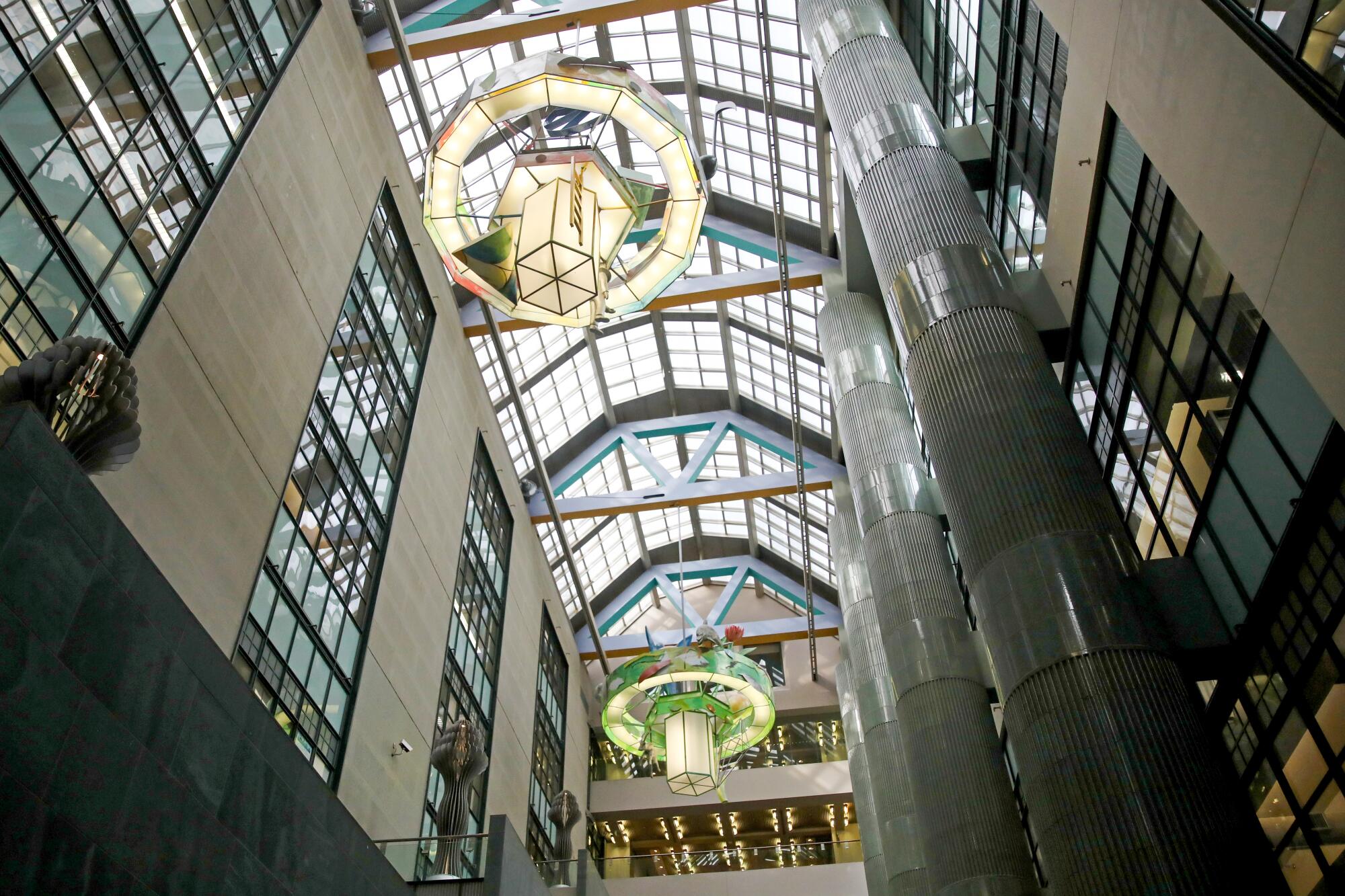 A glass-roof atrium with three massive chandeliers at the Central Library.