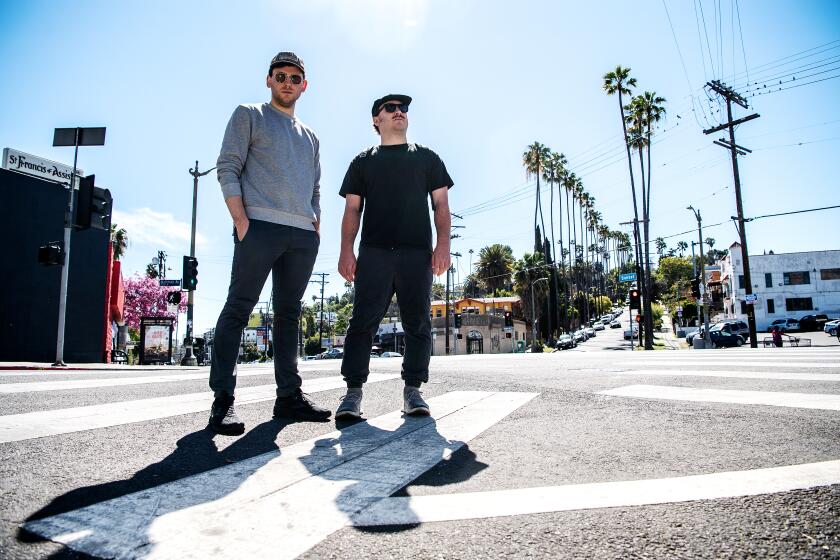 LOS ANGELES, CA - FEBRUARY 28: Portrait of friends Brooke Palmieri, left, and Zac Weather on Sunset Blvd., on Monday, Feb. 28, 2022 in Los Angeles, CA. The pair recently walked 50 miles from Pasadena to Redondo Beach. (Mariah Tauger / Los Angeles Times)