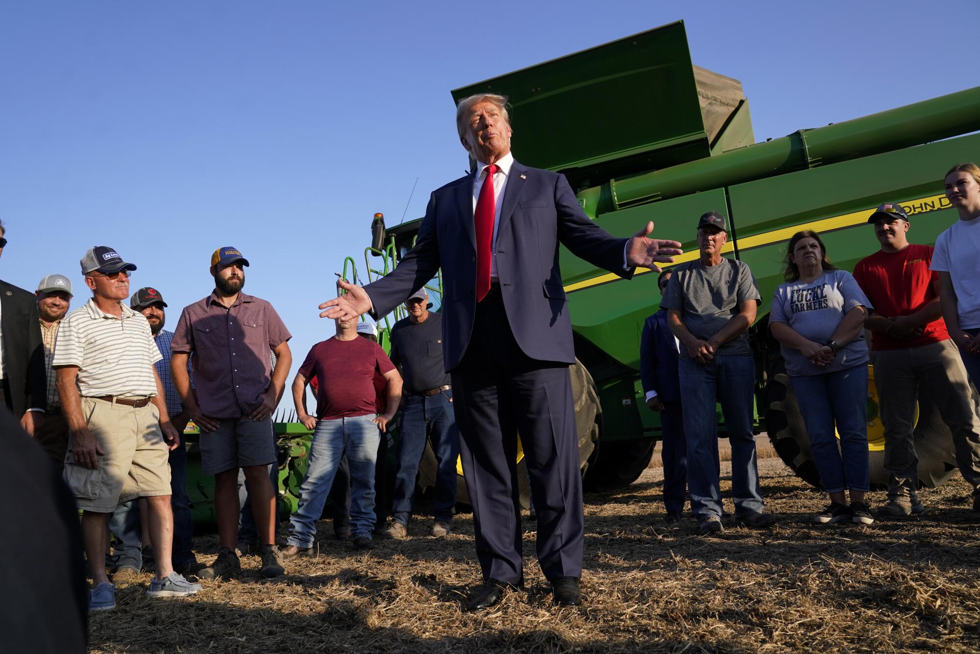 FILE - Former President Donald Trump speaks to reporters during a visit to the 