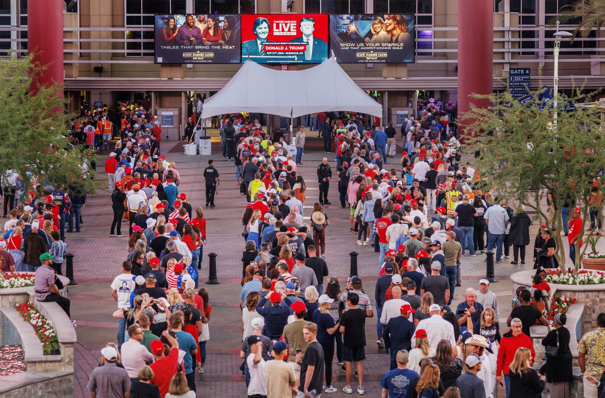 Trump supporters line up outside an area for a rally 