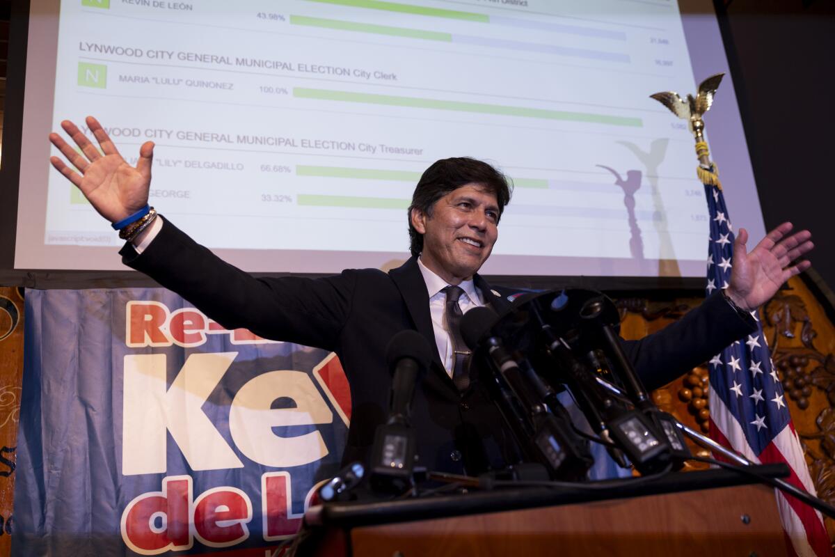 Kevin de Leon speaks to supporters as election results are seen on a screen during an election watch party in Los Angeles.