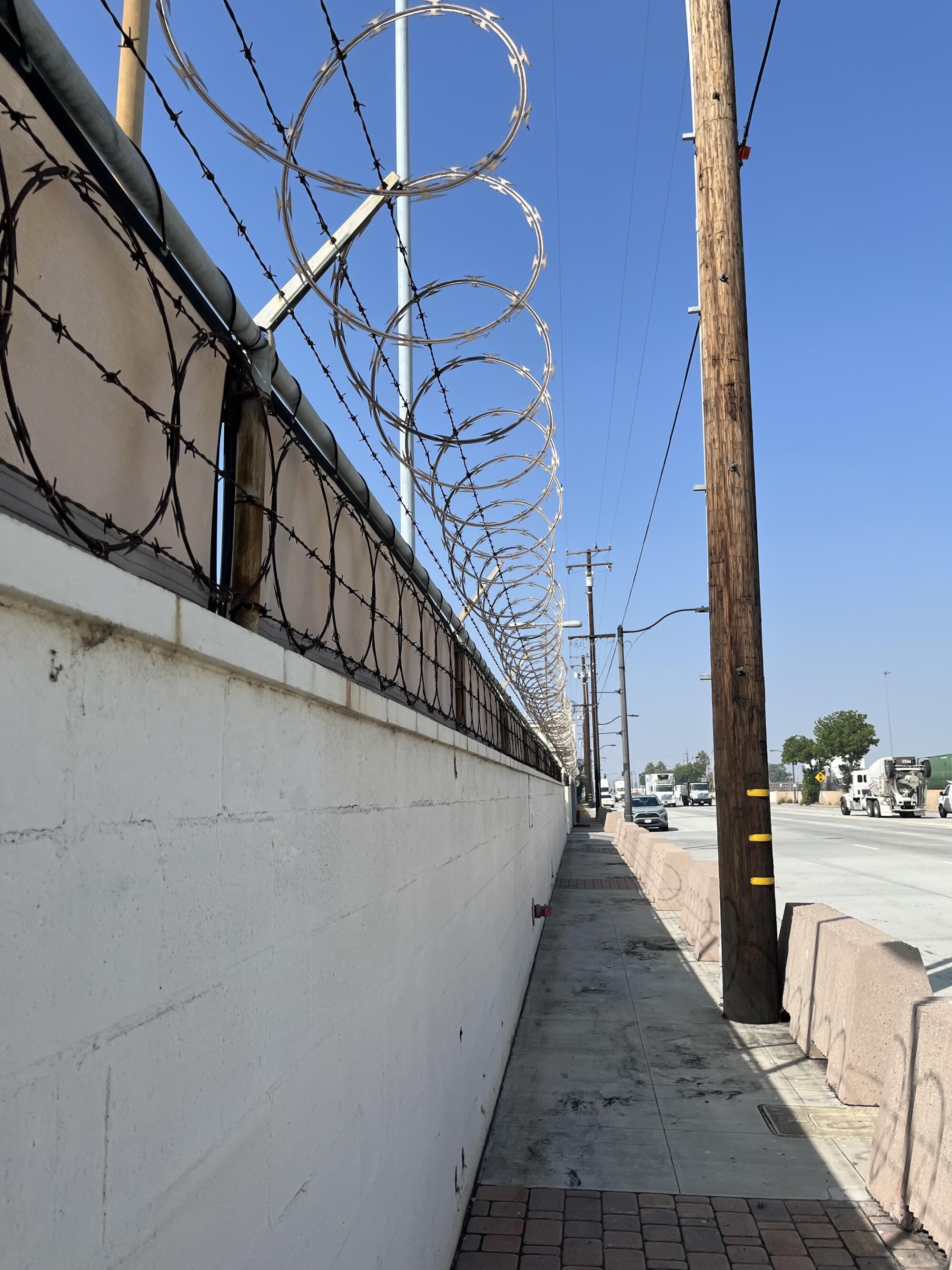 Razor wire along a fence in an industrial area near Commerce.