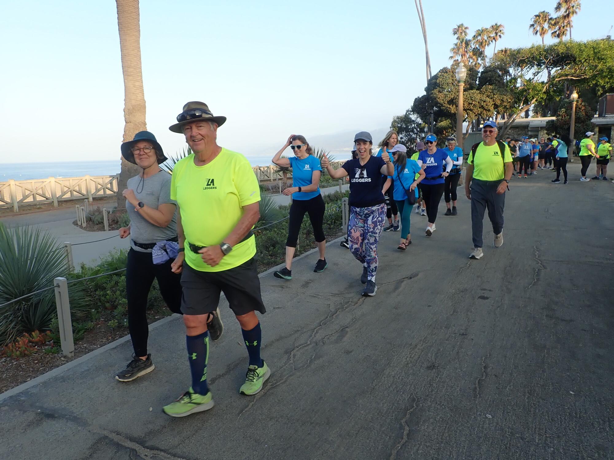 L.A. Leggers members walk on a path overlooking the ocean