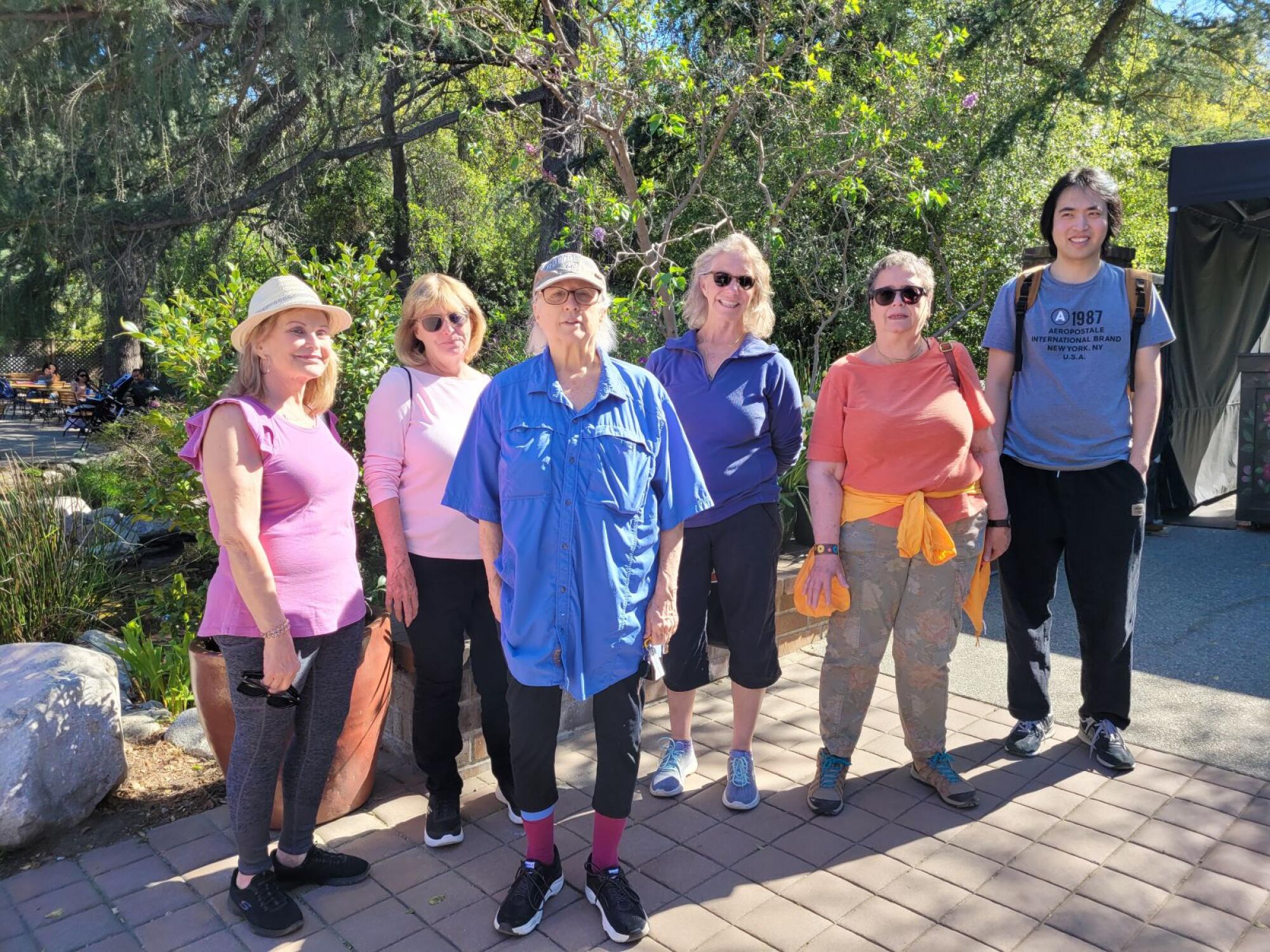 Slow Walkers Club members, of varying ages, standing outside in a line