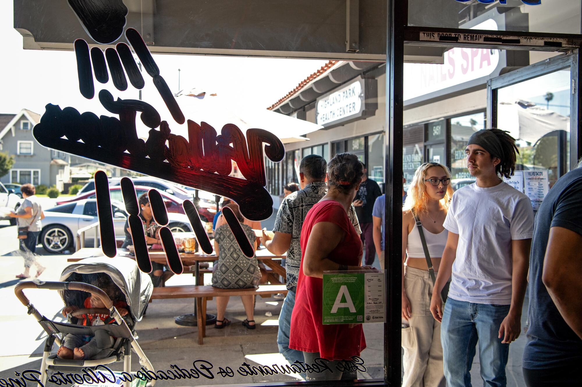 Hungry customers in line at Villa's Tacos in Highland Park