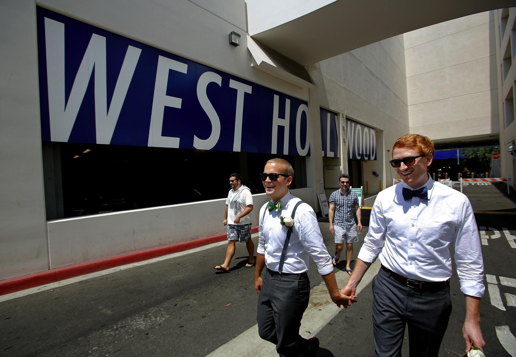 A couple holding hands in West Hollywood