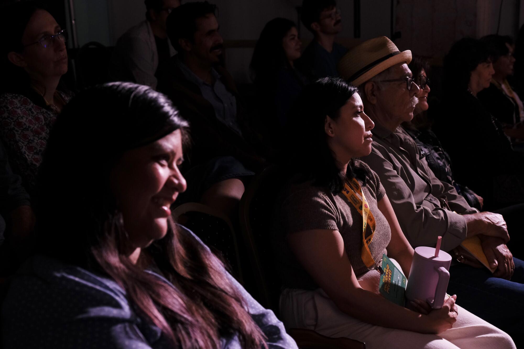 People seated in a theater watching a play.