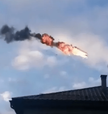 A drone flies over a Russian home after being hit