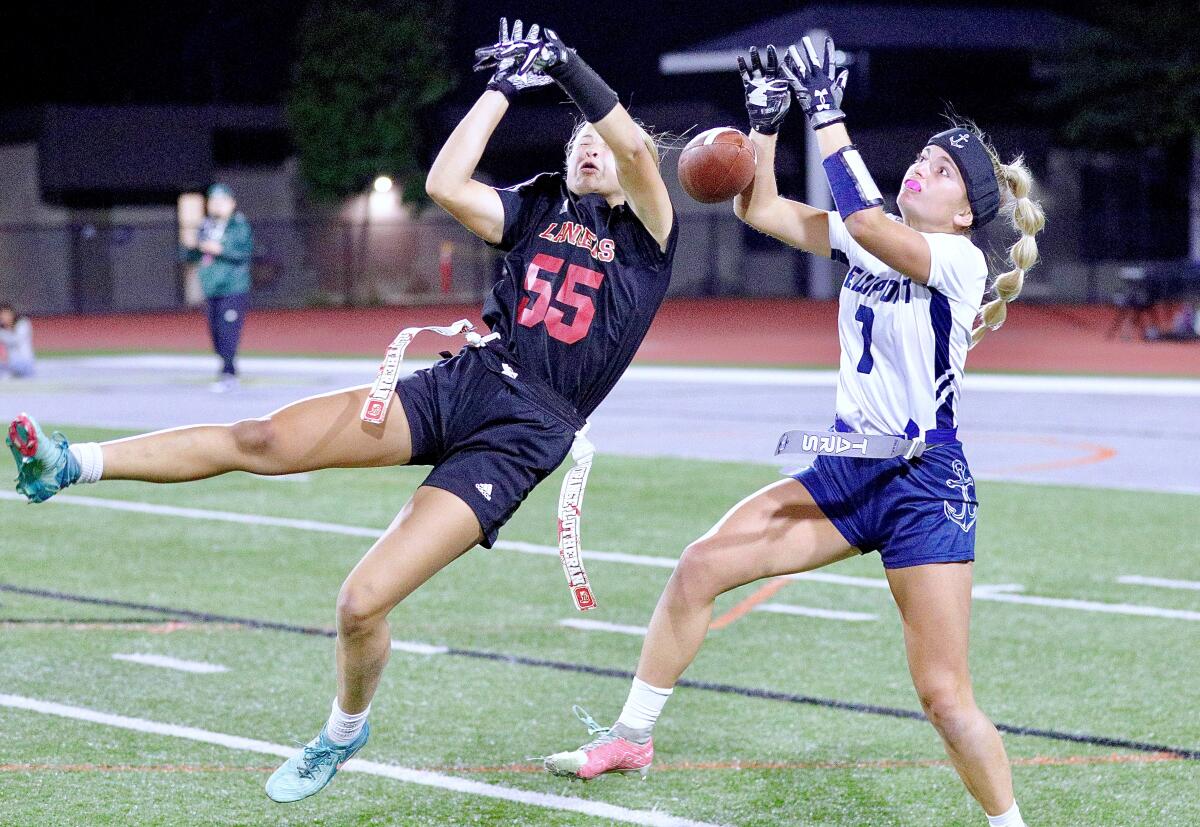 Orange Lutheran's Josie Anderson, left, knocks the ball away from Newport Harbor receiver Cooper Dick.