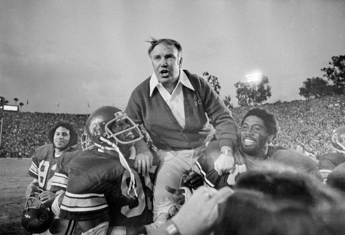 USC coach John Robinson is carried of the field after the Trojans' victory over Michigan in the Rose Bowl in 1977.