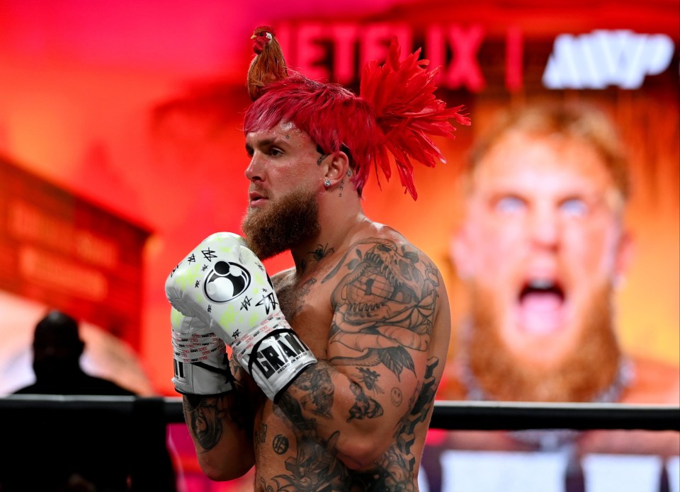 Jake Paul wears a red rooster cap ahead of his fight with Tyson