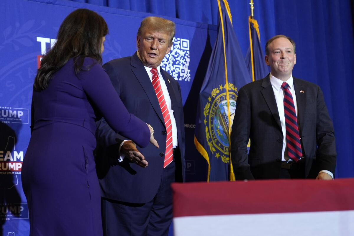 Donald Trump reaches to shake hands with a woman