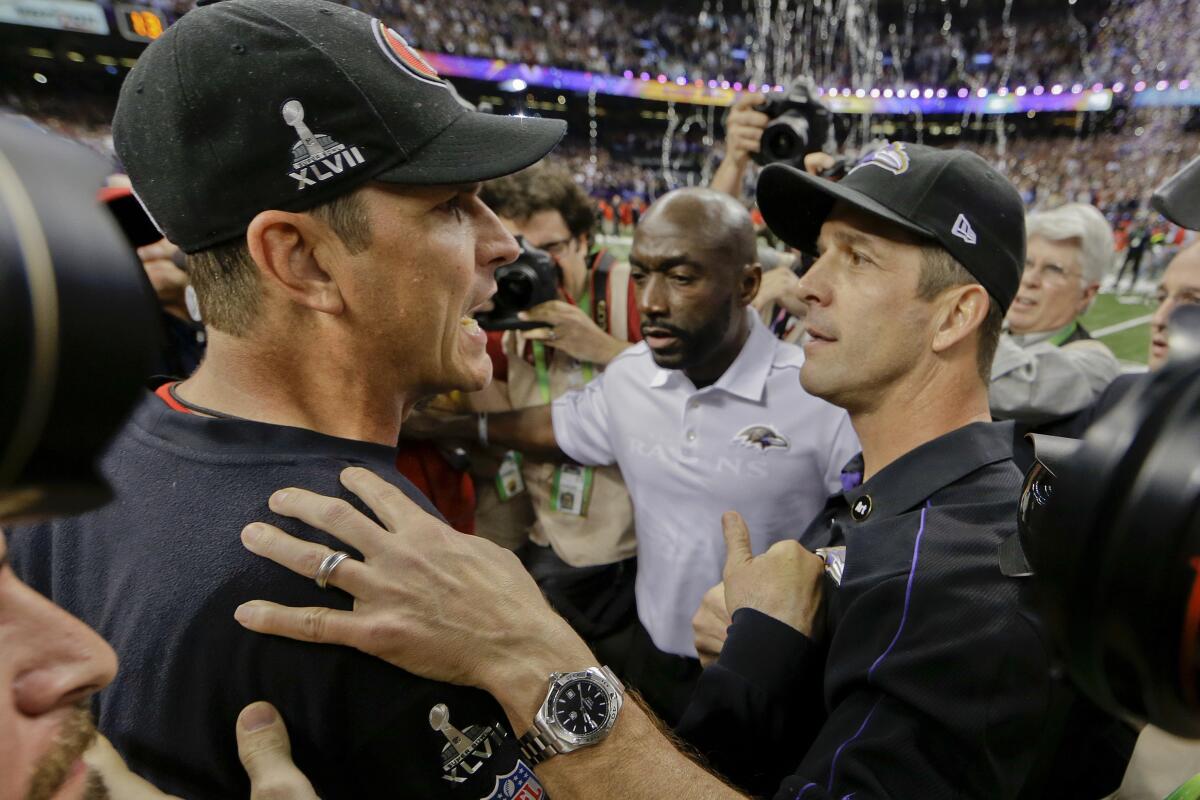  San Francisco 49ers coach Jim Harbaugh, left, greets Ravens coach John Harbaugh after Baltimore's Super Bowl win.