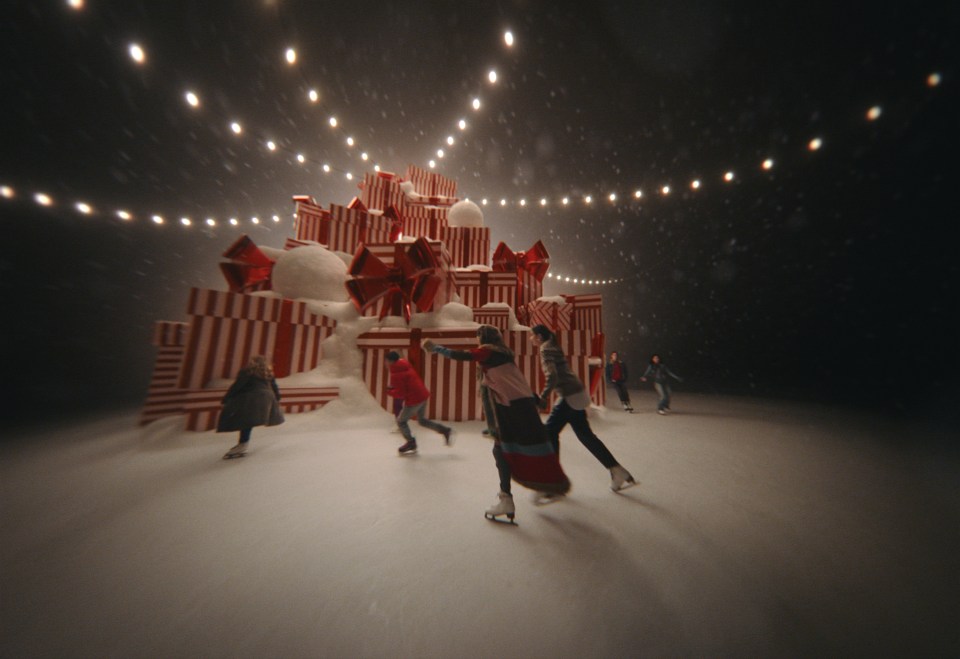 The sisters are shown ice skating in a magical scene