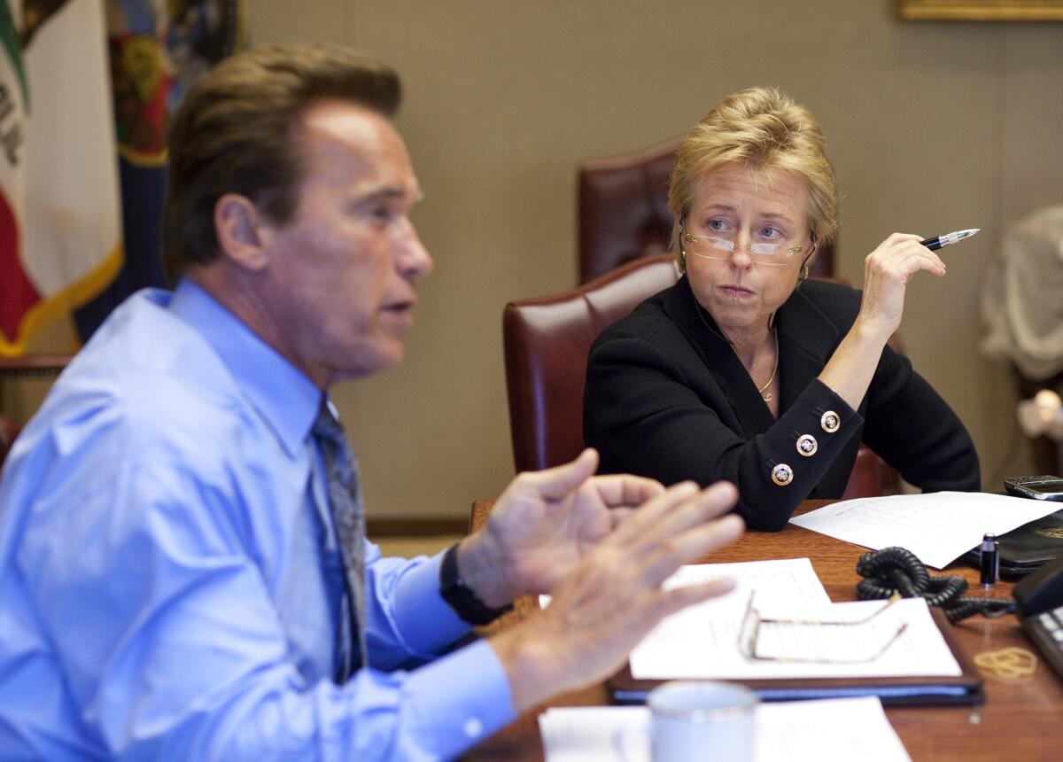 Then-Gov. Arnold Schwarzenegger attends a meeting with his chief of staff, Susan Kennedy, at the state Capitol in 2009.