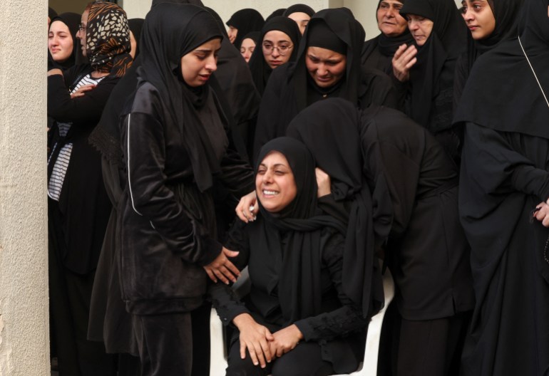 A mourner reacts during the funeral of her relative who was killed in Israeli strikes,