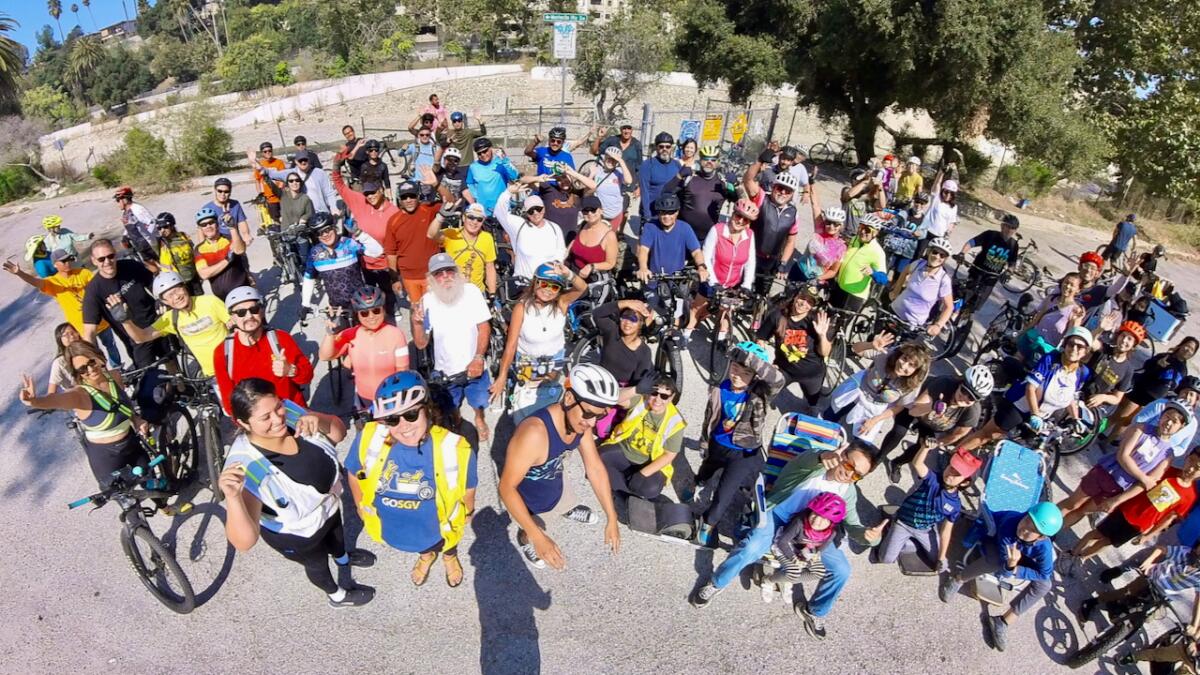 A large group of cyclists posing for a photo