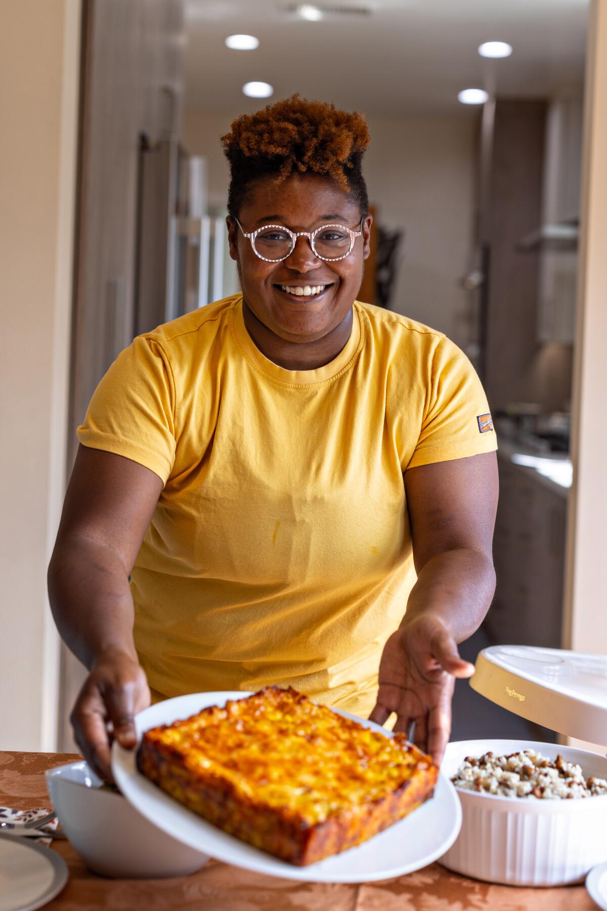 Rashida Holmes of Bridgetown Roti shows off a plate with her square macaroni and cheese pie