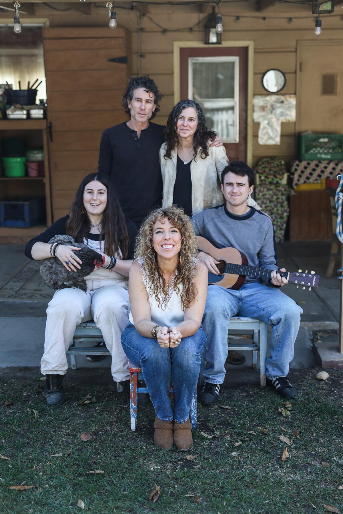 A group of people sitting together on a farm