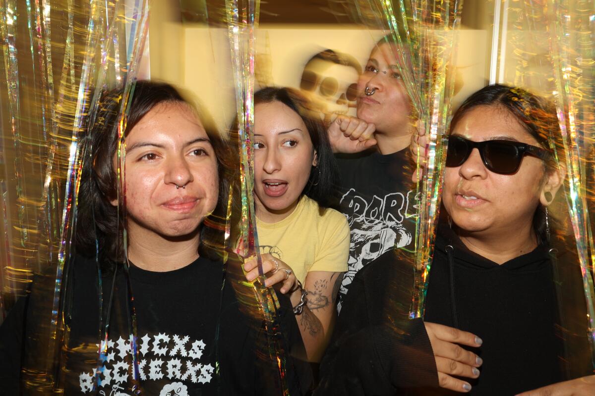 Group of Latina punk rockers pose for photo at South Gate Museum