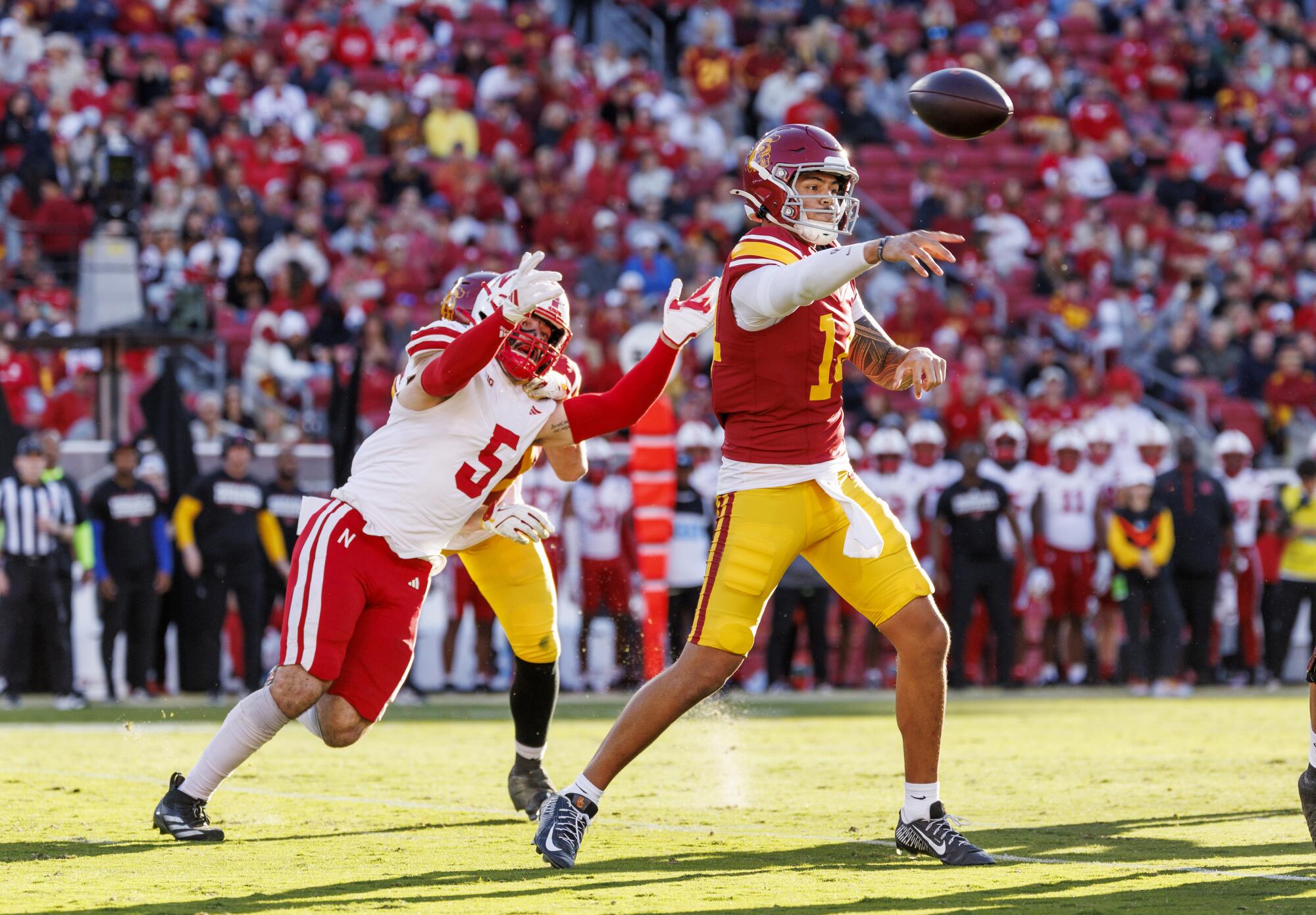 USC quarterback Jayden Maiava passes in front of Nebraska linebacker John Bullock at the Coliseum.