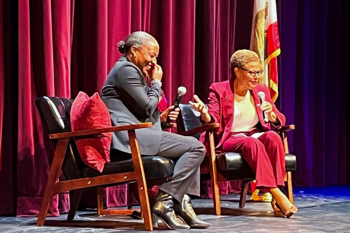 U.S. Sen. Laphonza Butler, left, shares a laugh on stage with Los Angeles Mayor Karen Bass.