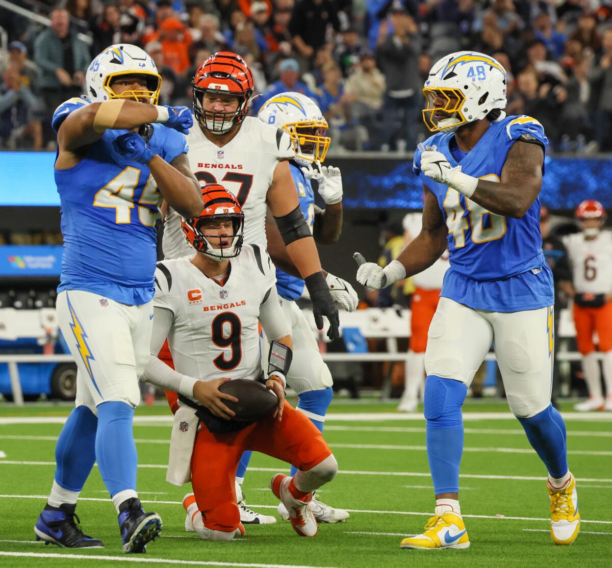 Chargers linebacker Tuli Tuipulotu (45) celebrates after sacking Bengals quarterback Joe Burrow (9).