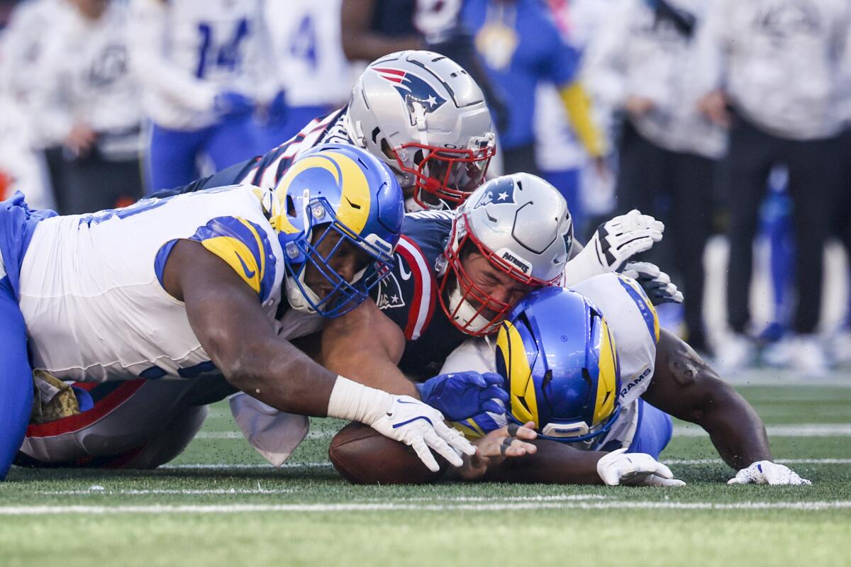 Rams defensive tackle Kobie Turner (91) recovers a fumble against the New England Patriots. 