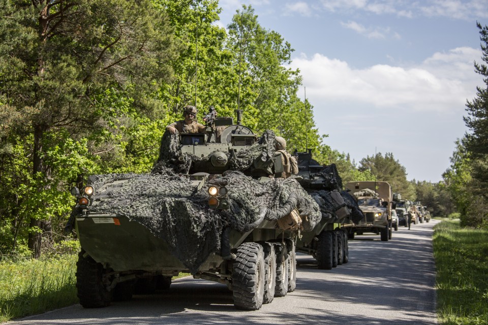 A US military convoy wait for aerial support alongside a road in Bro area