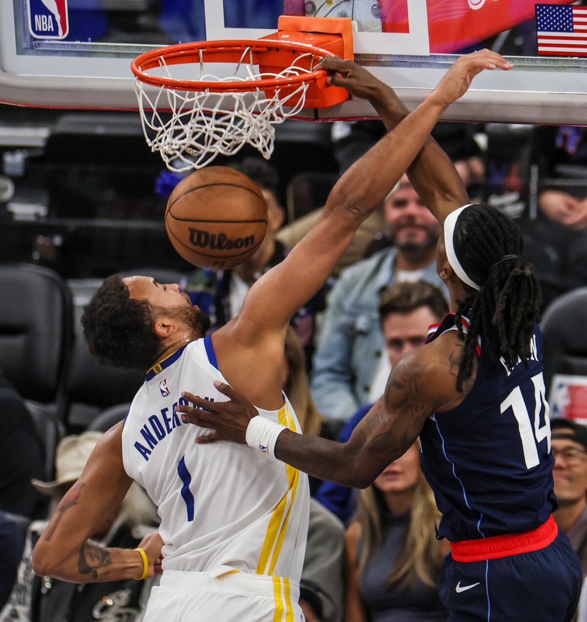 Clippers guard Terance Mann, right, dunks over Golden State Warriors forward Kyle Anderson during the second half Monday.