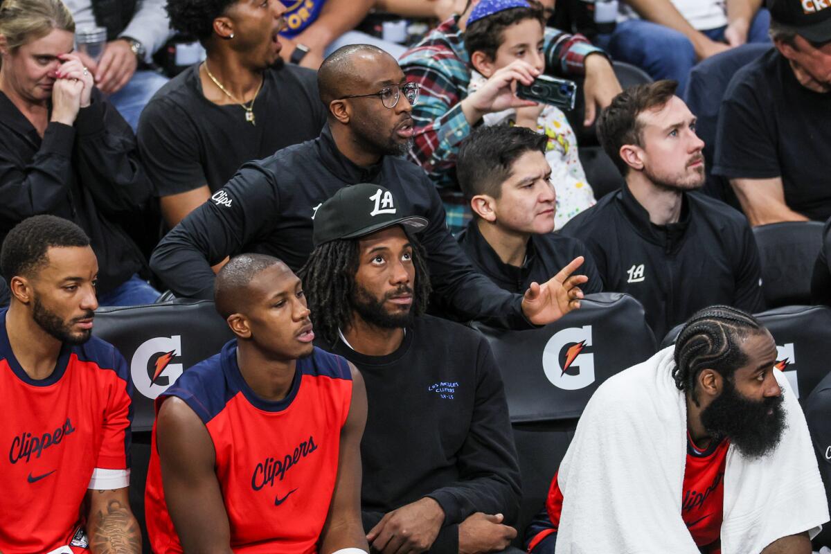 Injured Clippers star Kawhi Leonard watches from the bench during the Clippers' win Monday.