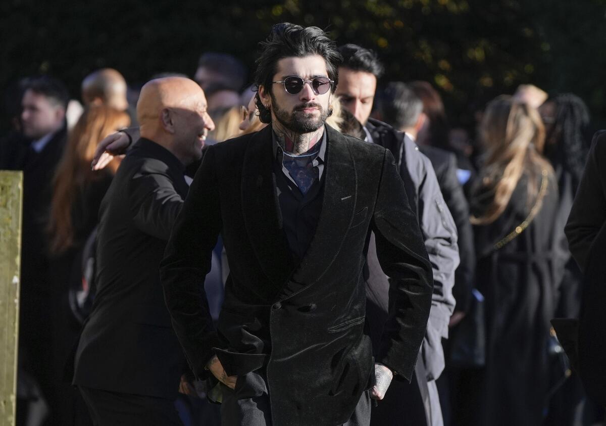 Zayn Malik walks after the funeral service for One Direction singer Liam Payne.