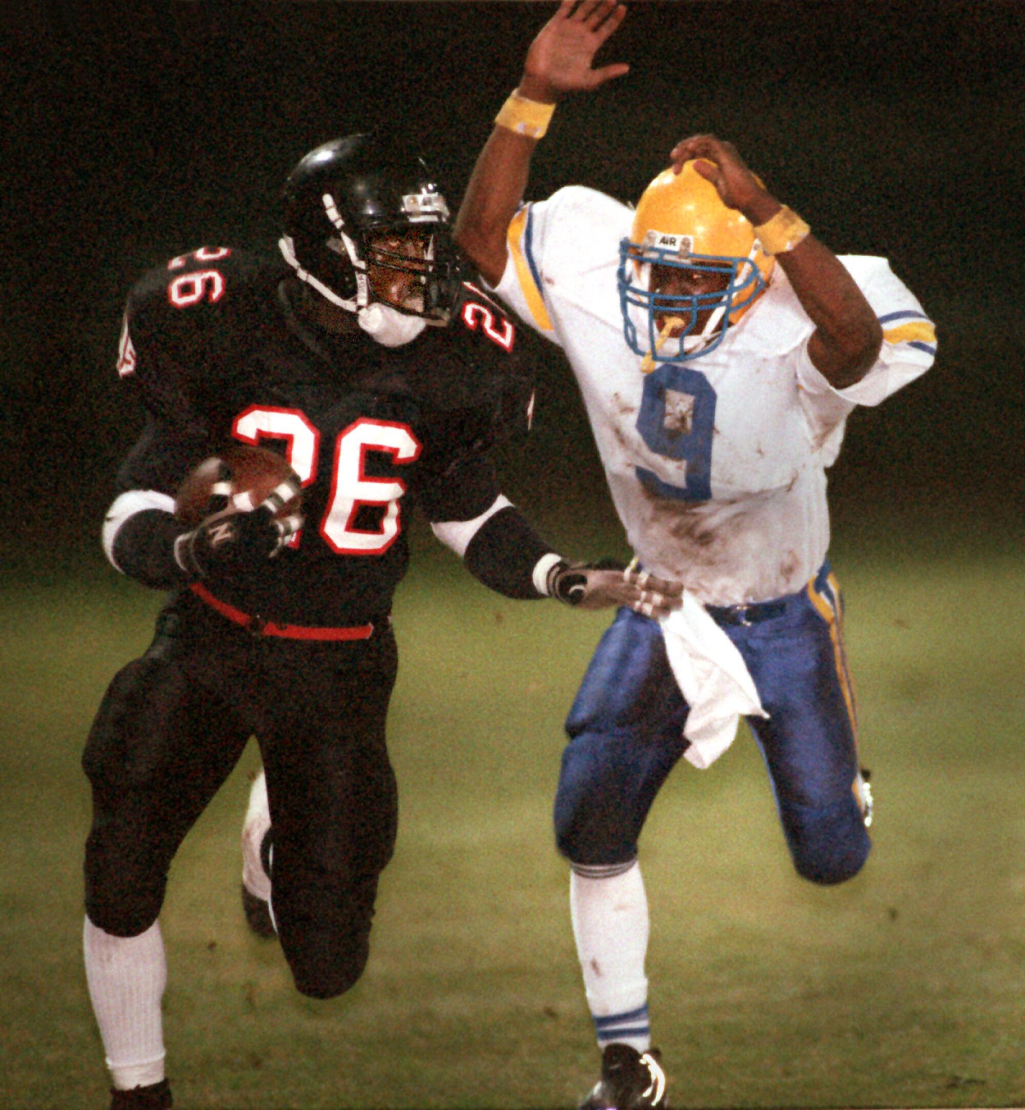 Tustin High's DeShaun Foster scores a touchdown as Valencia High's E.J.Smith tries to tackle him.