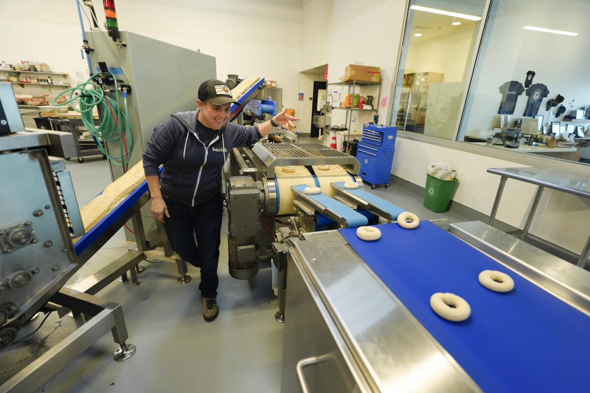 A woman in a food processing facility. 