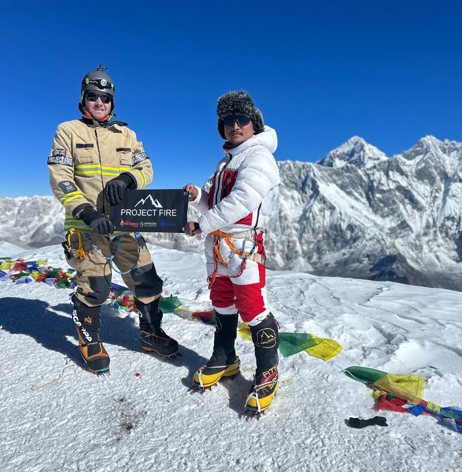 Rhys poses at the summit of Ama Dablam