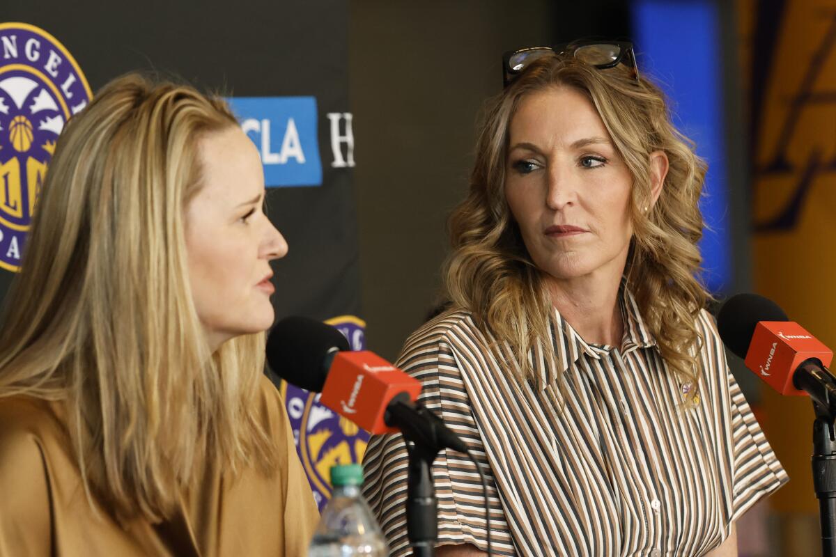 Sparks coach Lynne Roberts speaks during a news conference while sitting next to Sparks general manager Raegan Pebley.