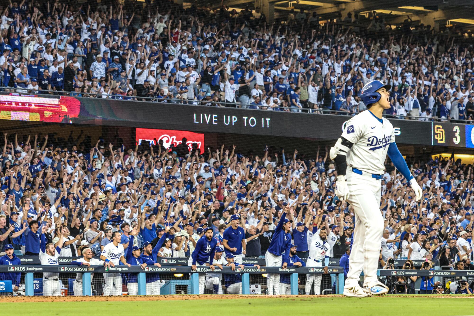 Dodgers designated hitter Shohei Ohtani hits a three-run homer against the San Diego Padres.