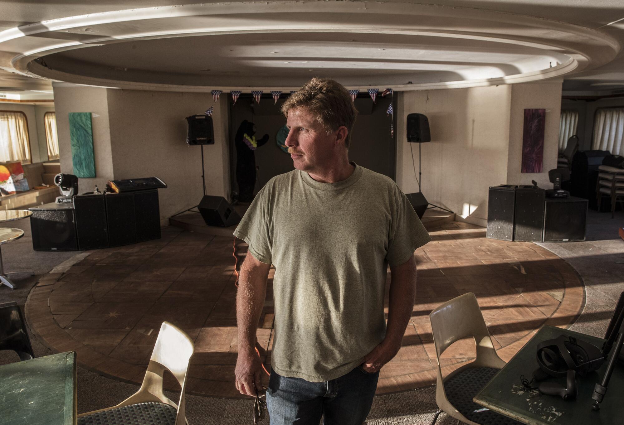 Chris Willson stands in the grand ballroom aboard the Aurora.